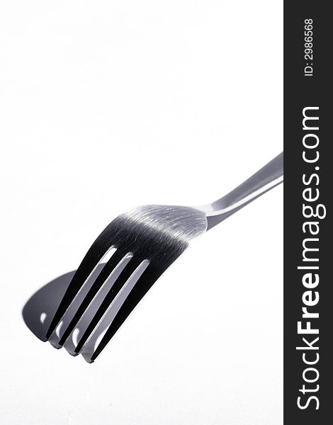 Top Os A Stainless Steel Fork With Shadow On A White Background