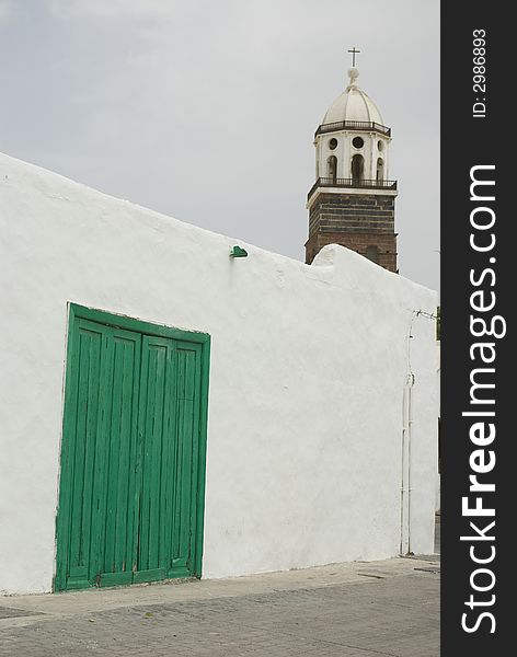 Old green door on a white wall