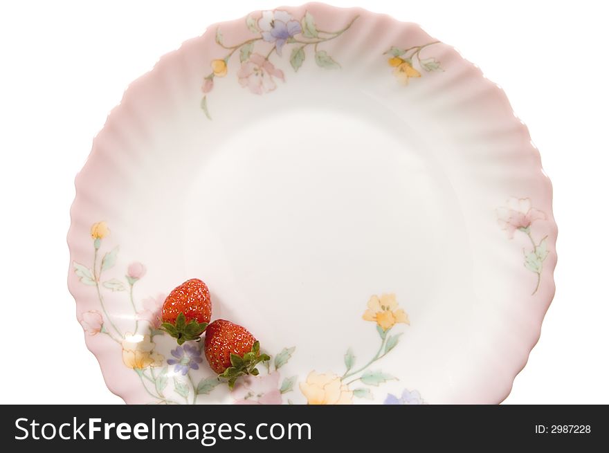 Two juicy strawberries on a tea saucer. Two juicy strawberries on a tea saucer