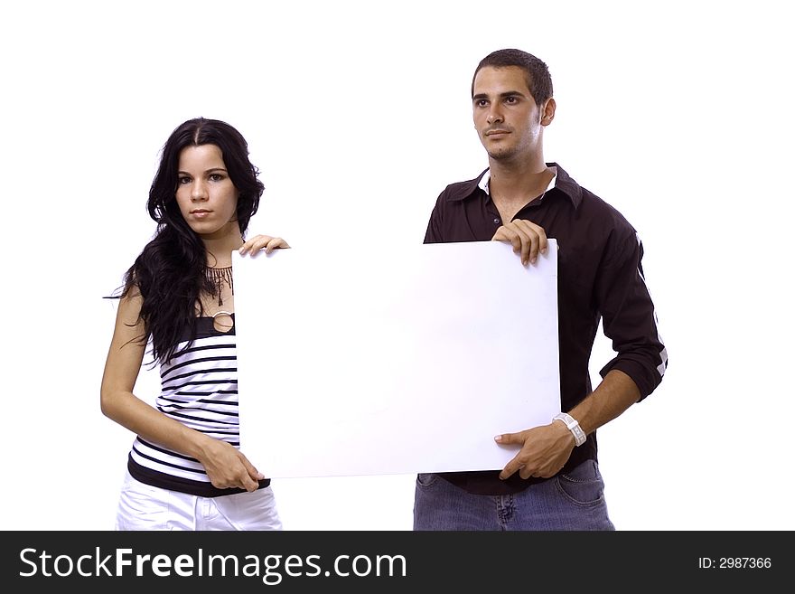 Young hispanic couple holding a blank banner - isolated over white. Young hispanic couple holding a blank banner - isolated over white