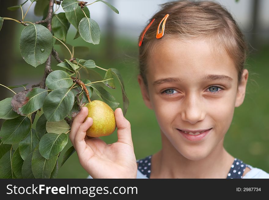 Girl holding a pear