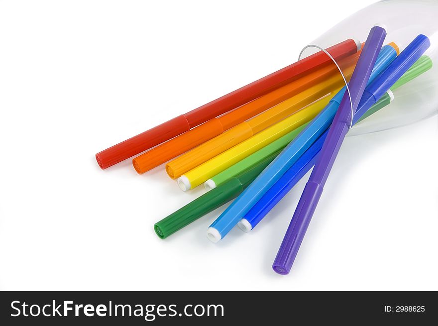 The coloredl pencils in a glass on the white background. The coloredl pencils in a glass on the white background