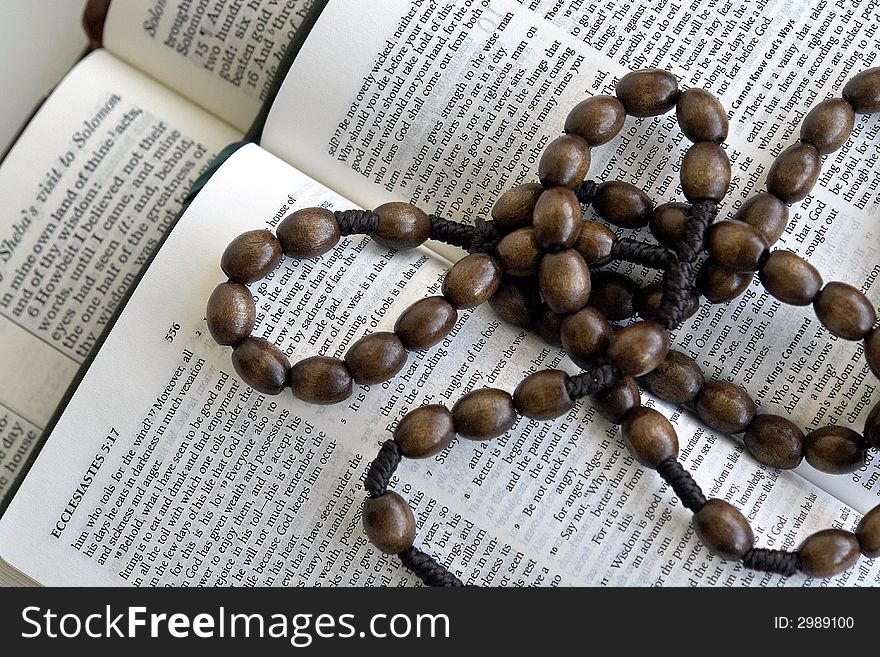 Bible and rosary on a white background. Bible and rosary on a white background