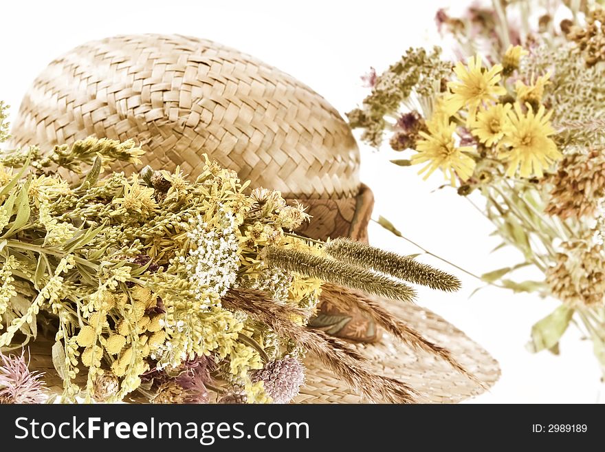 Straw hat and field flowers-retro beauty of a rural life