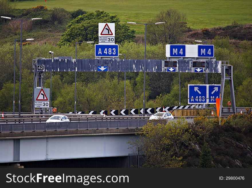 Motorway overhead gantry and signs on elevated section of M4 motorway in Swansea. Motorway overhead gantry and signs on elevated section of M4 motorway in Swansea