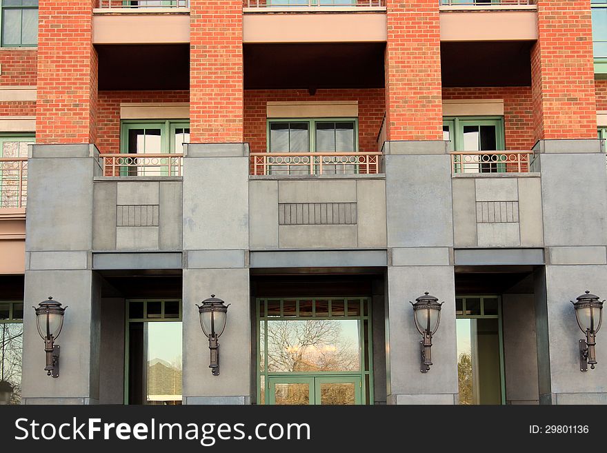 Attractive architecture of stone and red brick building with four impressive black lanterns at front entryway. Attractive architecture of stone and red brick building with four impressive black lanterns at front entryway.