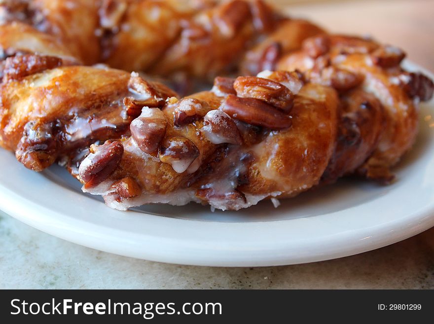 Braided pastry filled with pecans and glazed with sugar