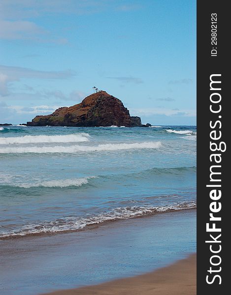 A view from a beautiful Maui beach with pristine water and waves coming on shore. A view from a beautiful Maui beach with pristine water and waves coming on shore.