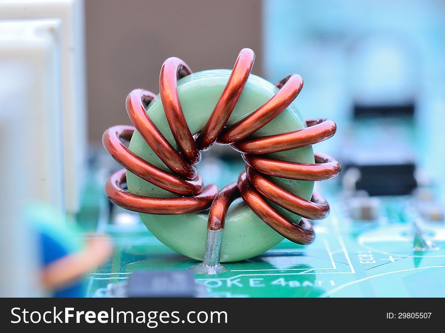 Close up of an electronic printed ferrite ring with mainboard background. Close up of an electronic printed ferrite ring with mainboard background