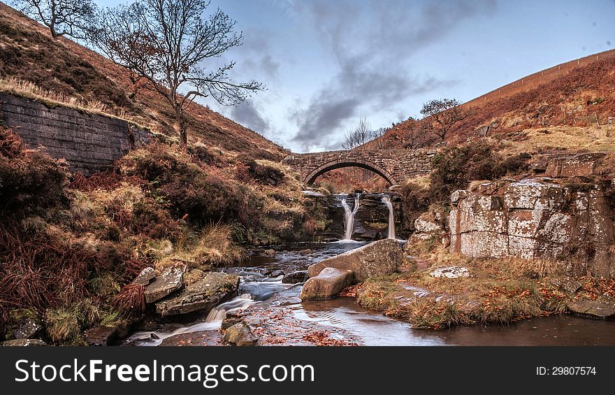 Waterfall and pack horse bridge in the peak District. Three Shire Head.
