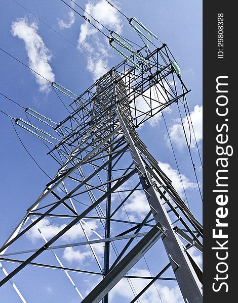 High voltage electric tower on a blue sky background. High voltage electric tower on a blue sky background.