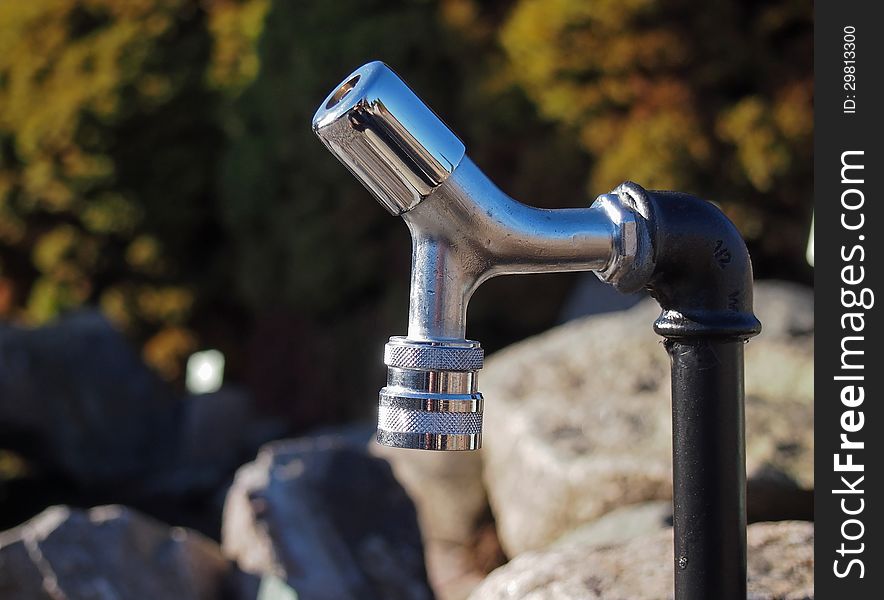 Close up image of chrome garden faucet