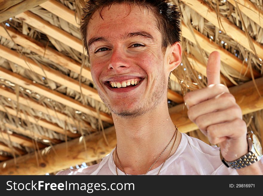 Happy smiling teenager enjoying the summertime at the beach.