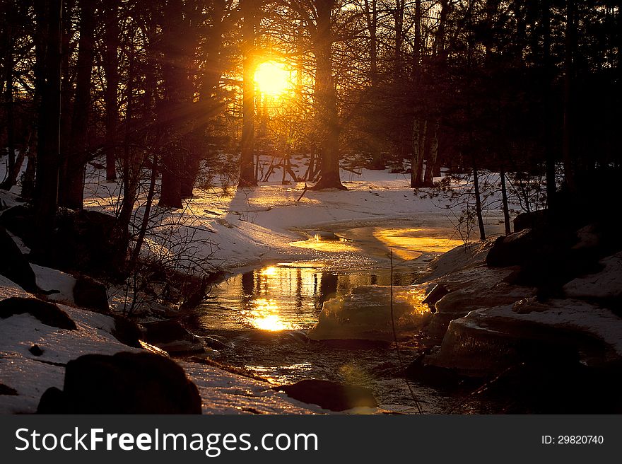 Sun reflected in the river, sunset when winter turns into spring. Sun reflected in the river, sunset when winter turns into spring