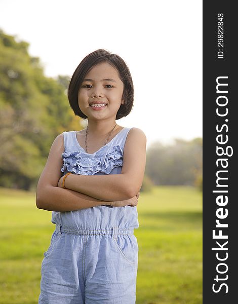 Asian little girl smiling happily in the park