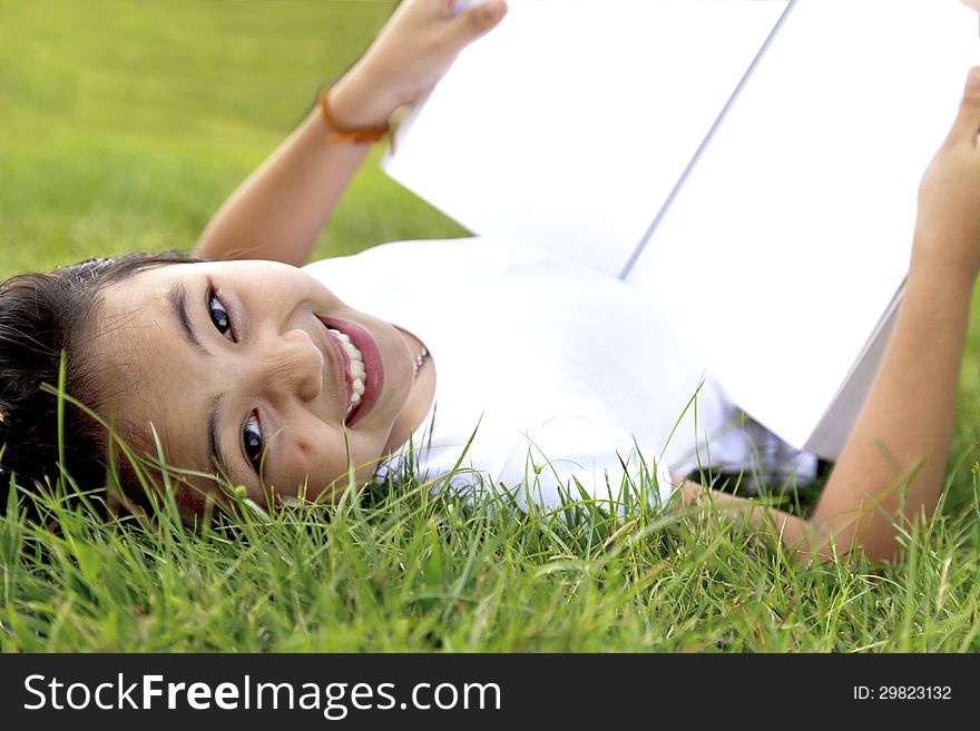 Girl Relax And Reading A Book In The Park