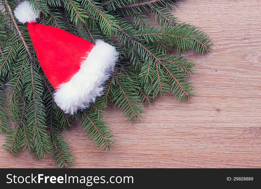 Santa's hat hanging on fir branches. Santa's hat hanging on fir branches