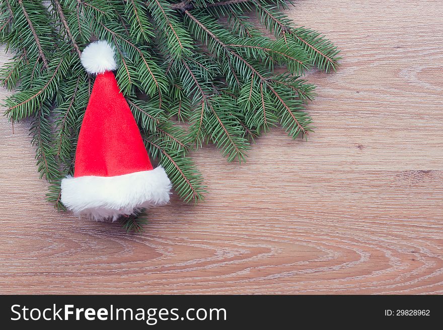 Santa's hat hanging on fir branches. Santa's hat hanging on fir branches