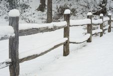 Snow Covering A Split Rail Fence. Royalty Free Stock Images