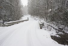Snow Covers A Narrow Mountain Bridge. Stock Images