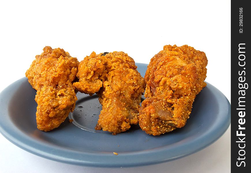 Spicy fried chicken on the blue dish