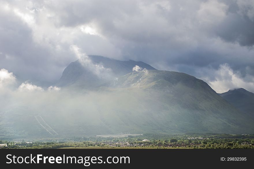 Ben Nevis , highest mountain in the British Isles, view from the road to Glenfinnan over Loch Eil. The mount is in the middle of fog and clouds