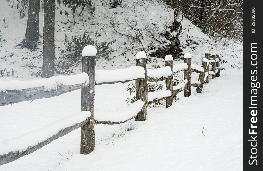 Snow Covering A Split Rail Fence.