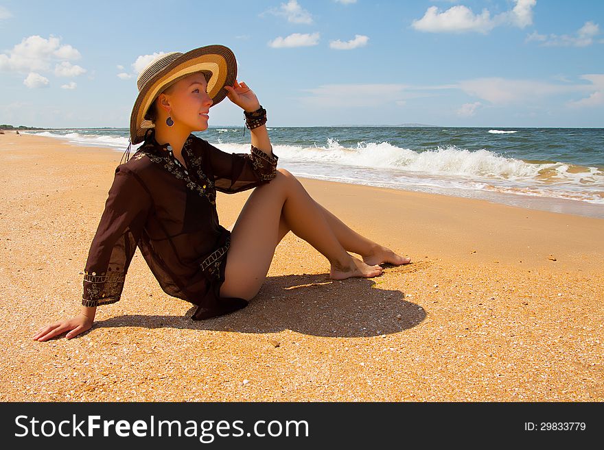 Girl in broun on a summer sea beach. Girl in broun on a summer sea beach