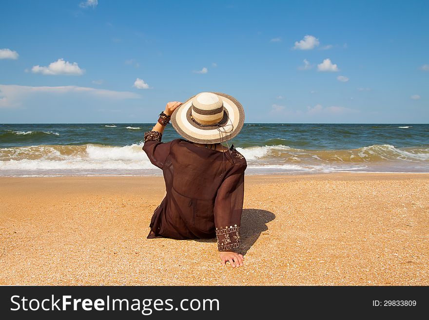 Girl in broun on a summer sea beach. Girl in broun on a summer sea beach