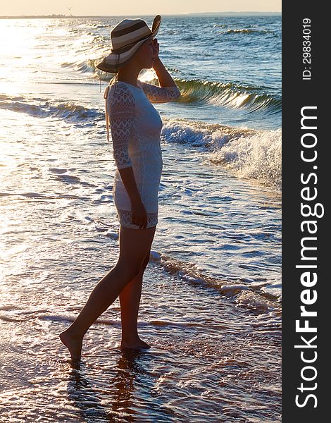 Young woman standing  in sea looking ahead