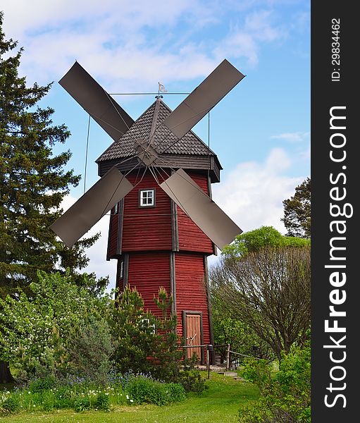 Old wooden windmill in countryside. Vertical frame