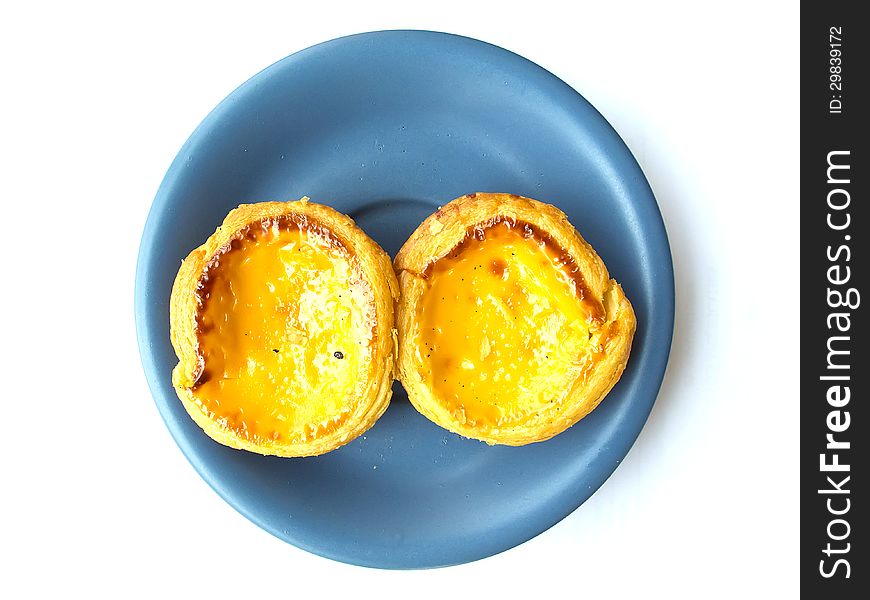 Egg tart isolated on white background with blue dish