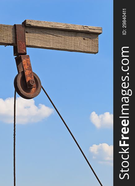 The rusty pulley with blue sky