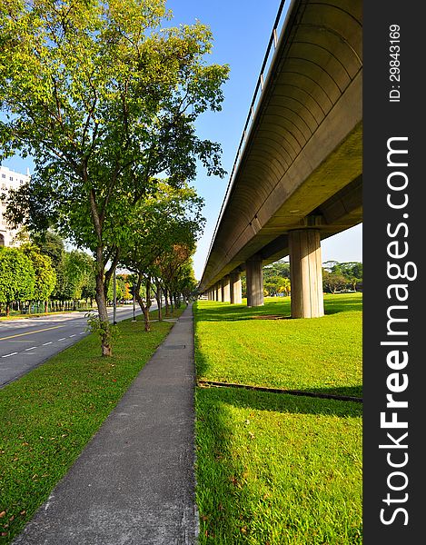 Perspective view of walkway and elevated train tracks at Yio Chu Kang (Singapore) on a sunny day. Perspective view of walkway and elevated train tracks at Yio Chu Kang (Singapore) on a sunny day