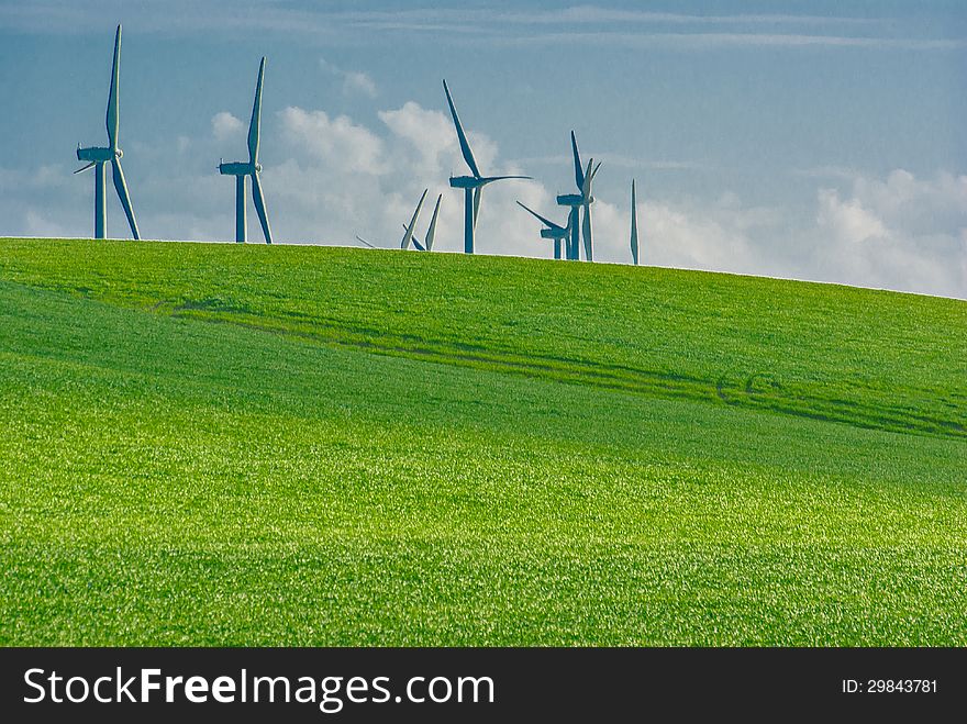Several windmills in the countryside horizon