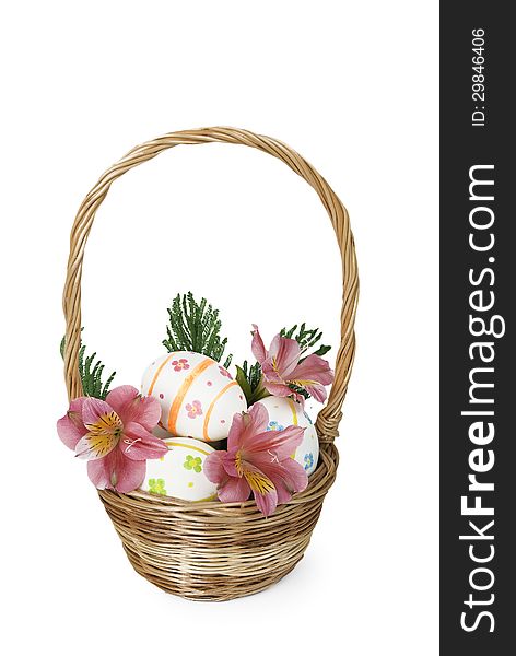 Easter eggs with pink flowers in a wicker basket. Easter eggs with pink flowers in a wicker basket