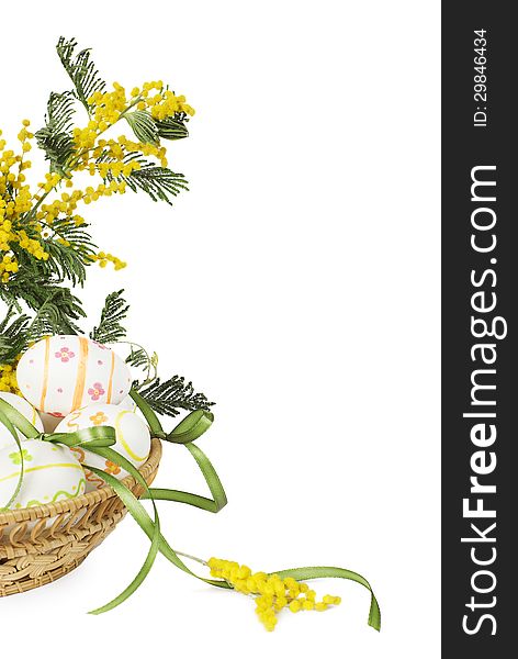 Easter eggs with yellow flowers in a wicker basket. Easter eggs with yellow flowers in a wicker basket