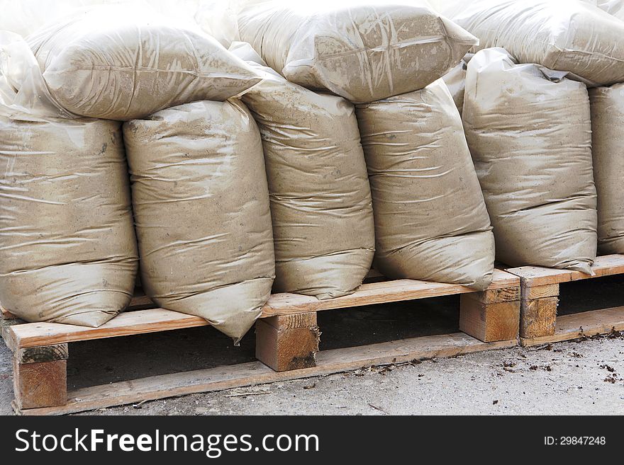 Construction mixtures on wooden pallet at storehouse