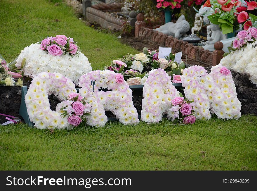 A floral wreath at a graveyard