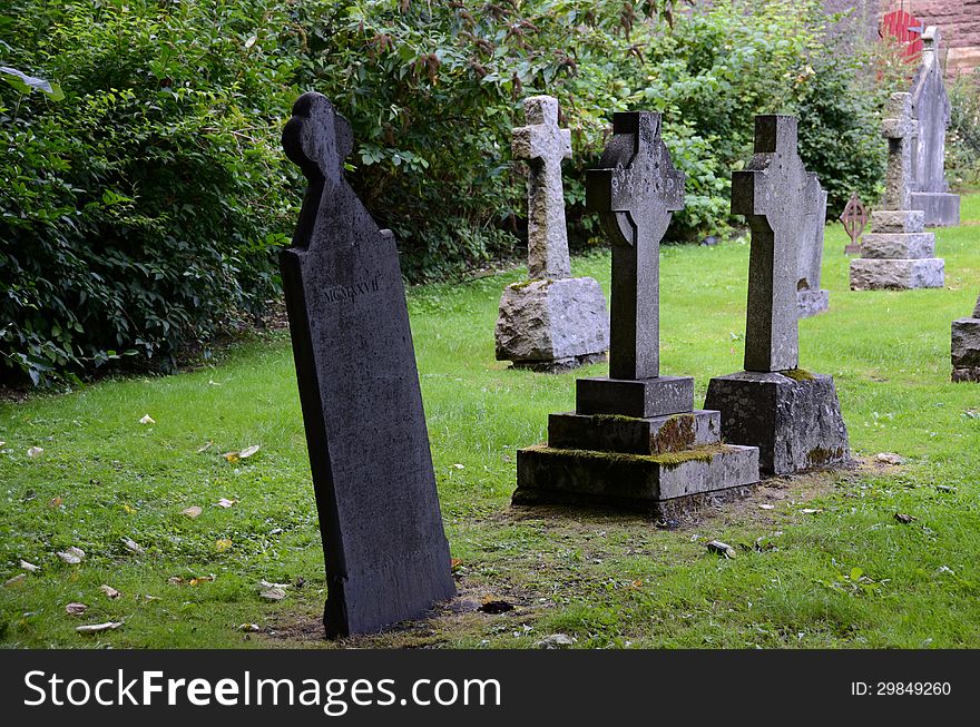 A row of tombstones at a graveyard