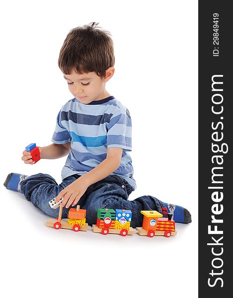 Little boy is making a train of wooden colorful pieces. Little boy is making a train of wooden colorful pieces.