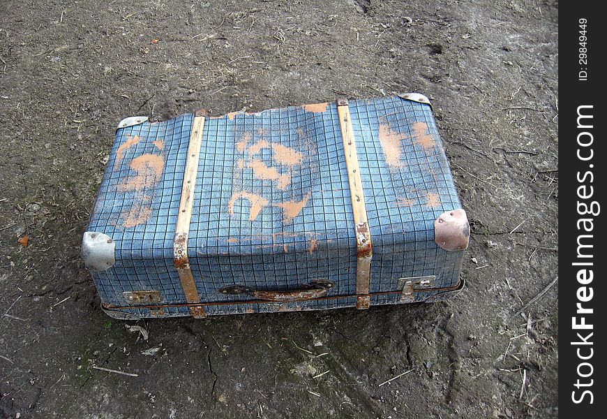 Old suitcase on the ground