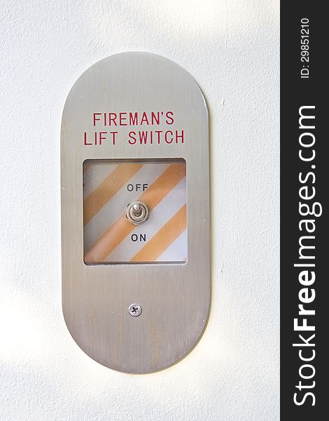 Fireman's lift switch on the white wall. Fireman's lift switch on the white wall