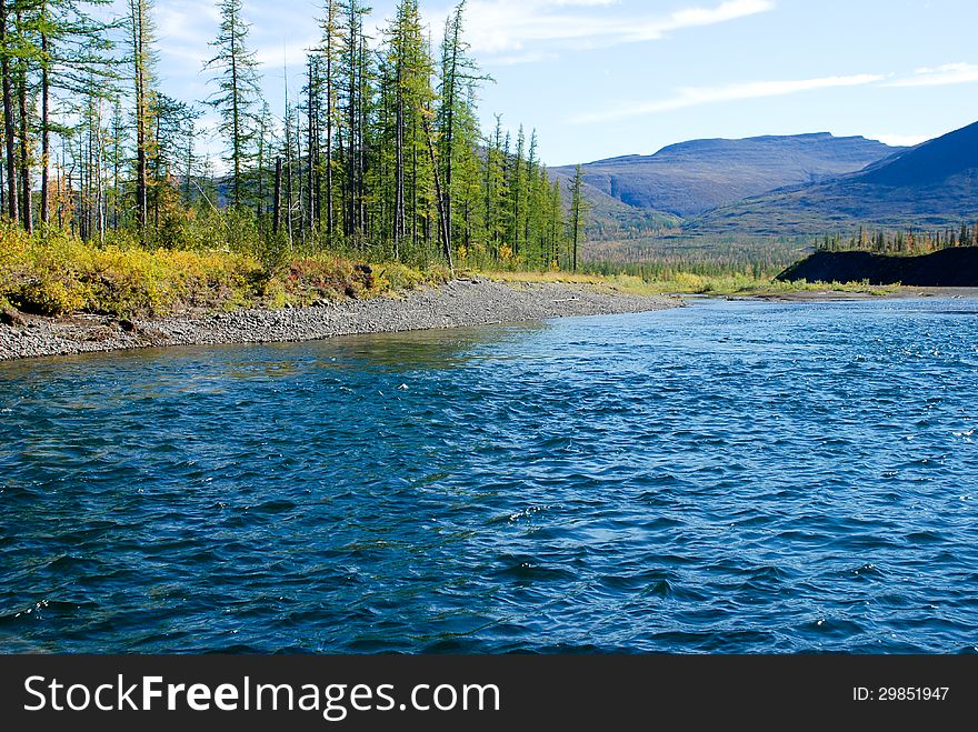 The river and its surroundings at the end of the summer. The Putorana Plateau, Russia, Taimyr Peninsula. The river and its surroundings at the end of the summer. The Putorana Plateau, Russia, Taimyr Peninsula.