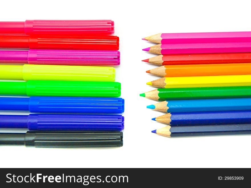 Two stacks colorful of pencils and markers on white