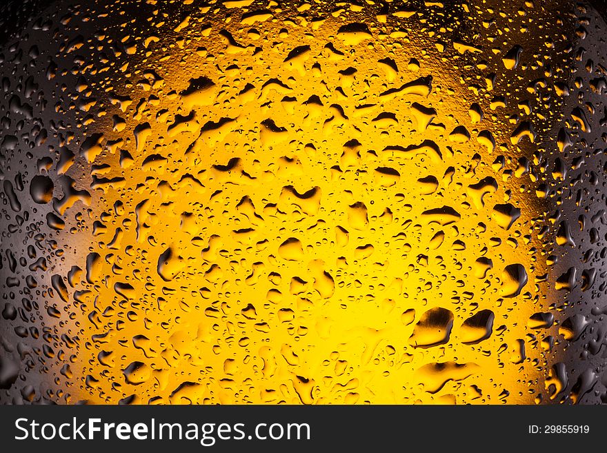 Сlose shot of drops on a bottle beer.