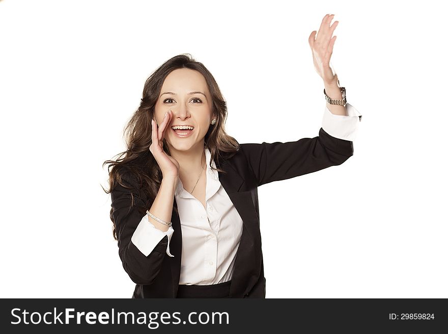 Satisfied and happy woman shouting with one hand next to her mouth