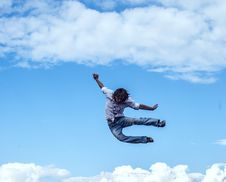 Guy Jumps Up Against The Sky Like He Is Free Royalty Free Stock Image