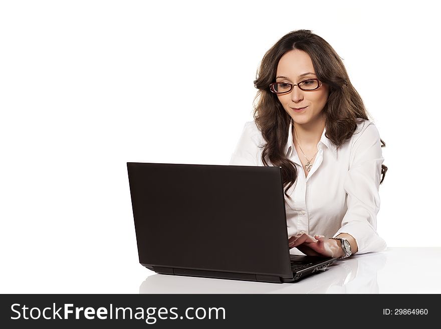 Nice smiling girl communicating with someone on her laptop on white background. Nice smiling girl communicating with someone on her laptop on white background