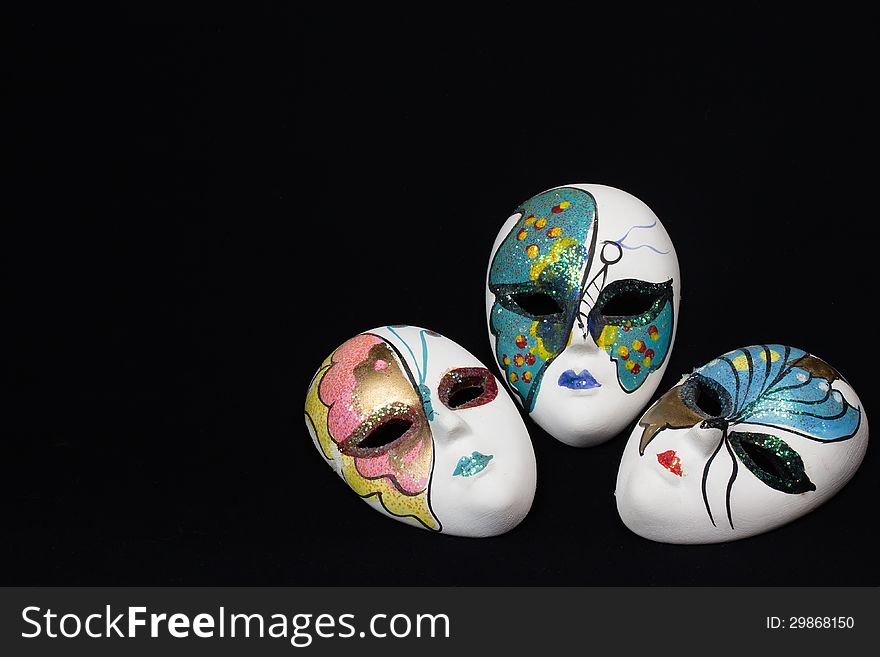 Traditional venetian carnival masks with black background.